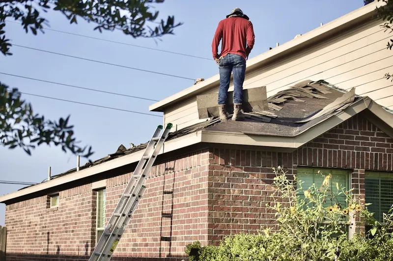 Professional roofer working on a residential roof in Oakland
